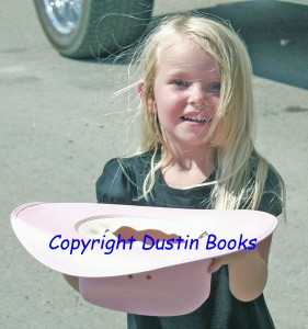 The prettiest cowgirl in the parade asks politely for some candy.