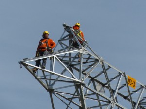 Power line construction workers wait 200 feet above the ground for a part to be delivered by helicopter in a remote forest in British Columbia. Back in the U.S., we can't even muster the will to build the Keystone Pipeline.